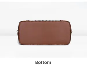 Detail view showing the reinforced rectangular bottom and oil-edged finish of brown shell bag