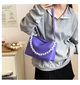 Detail showing fashion purple underarm bag with decorative white matte acrylic chain