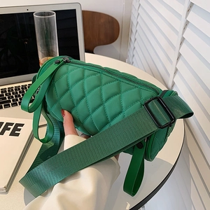 Bright green quilted nylon cylinder crossbody bag with wide strap in a modern setting