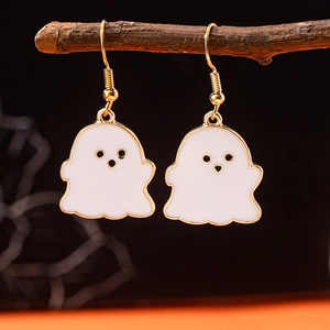 Macro shot of Halloween ghost earrings hanging on dry branches with a festive atmosphere