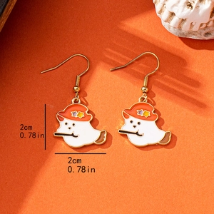 Halloween ghost earrings with orange hats in white enamel on warm orange background