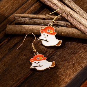 Cute Halloween ghost drop earrings with orange star hat and pipe on rustic wood background