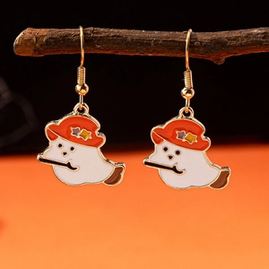 Detail of cute ghost earrings with orange wizard hat and magic wand on wooden branch