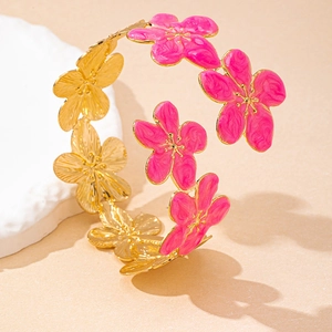 Detail of elegant gold-plated flower arm cuff featuring rose pink enamel petals