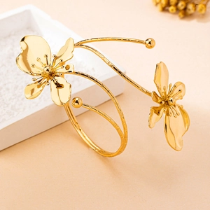 Detail of elegant gold-plated wrap bracelet featuring intricate flower petal design