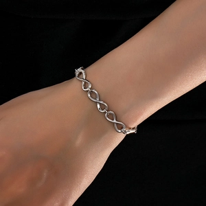 Polished silver infinity link bracelet for women featuring minimalist Mobius design on wrist