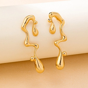 Detail view of irregular gold liquid metal earrings with smooth droplet pendants