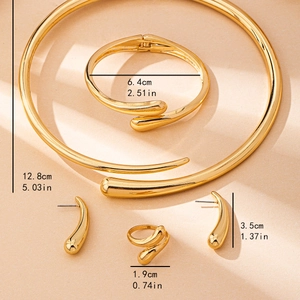 Elegant gold snake-style jewelry set with choker bracelet earrings and ring on beige