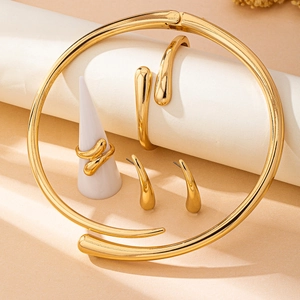 Polished gold jewelry set with fluid organic necklace bracelet earrings and ring