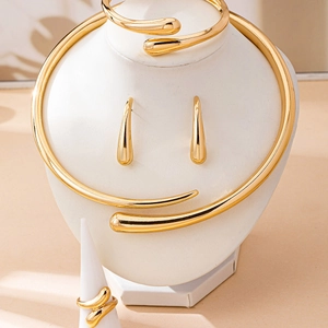 Golden snake-shaped open jewelry set including necklace, bracelet, ring, and earrings