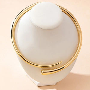 Minimalist gold geometric metal collar necklace with sleek open spring design on white neck model