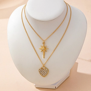 Double-layered gold necklace featuring a sparkling octagram star and paved heart pendants