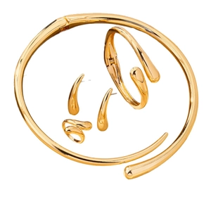 Golden minimalist jewelry set with snake style necklace, bracelet, ring and earrings