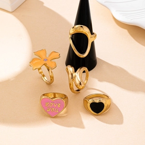 Five-piece gold ring set featuring colorful enamel hearts and floral patterns