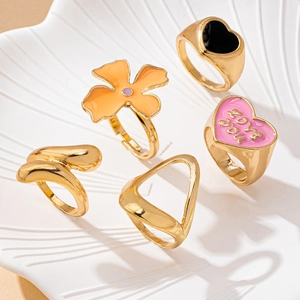 Close-up of five-piece fashion ring set with colorful enamel hearts and flowers