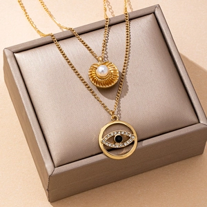 Gold-plated layered necklace featuring mother of pearl star and evil eye diamond pendants