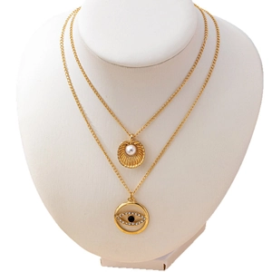 Gold-tone layered necklace with shell pearl pendant and diamond-set evil eye charm