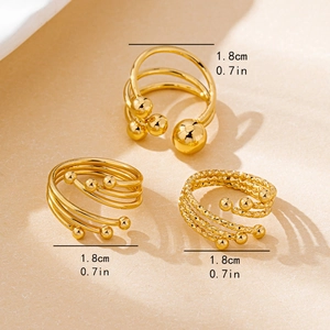 Three-piece gold layered open rings with ball accents and engraved texture detail