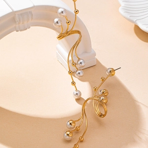 Artistic golden geometric earrings with elegant white pearls in a stylized vine design