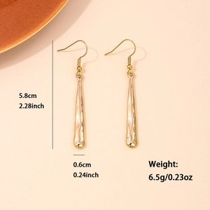 Long geometric gold drop earrings with hammered texture and 5.8cm streamlined design