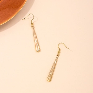 Long geometric gold drop earrings with irregular textured surface and minimalist style
