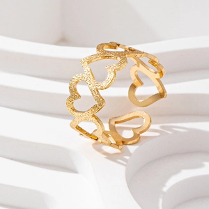Minimalist gold open ring featuring hollow heart designs and sandblasted matte texture
