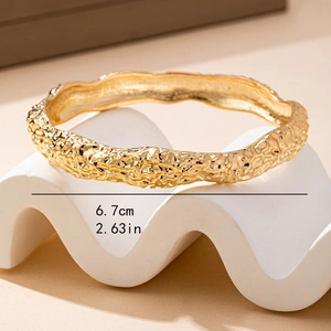 Gold geometric irregular textured bracelet with 6.7cm diameter dimension marking