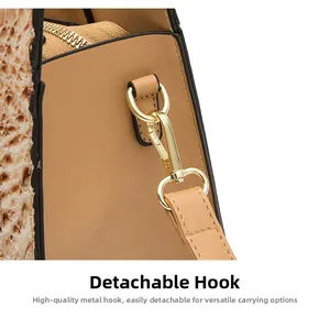Detail of high-quality gold swivel hook and textured faux crocodile leather bag strap