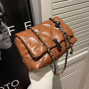 Brown quilted chain shoulder bag with metal ball charm and minimalist crossbody design