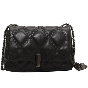 Minimalist black quilted crossbody bag with diamond stitch and dark metal chain strap