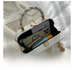 Internal view of white quilted crossbody bag showing space for phone and makeup accessories