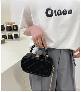 Classic black quilted crossbody bag with gold twisted handle and chain strap detail