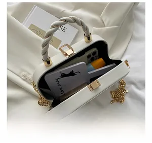 Detail view showing interior capacity of a cream box bag with gold chain strap