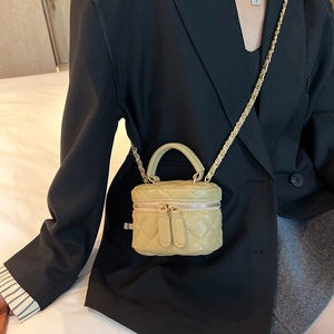 Sage green quilted mini vanity chain bag styled with a professional black blazer jacket