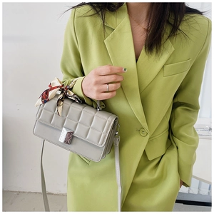 Detail of light grey quilted crossbody bag with decorative scarf and metal 4G logo lock