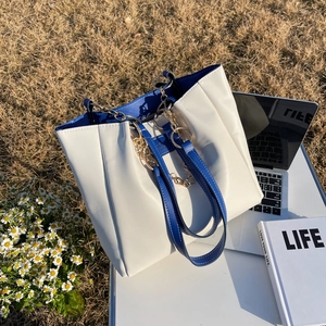 Chic cream and navy large tote bag with gold chain and pleated faux leather design