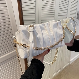 White ruched shoulder bag with gold chain and adjustable strap in minimalist style
