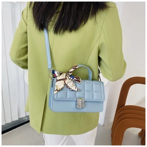 Detail of light blue quilted PU leather handbag with vintage floral scarf handle wrap