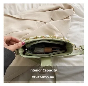 Internal view showing capacity of the light green PU leather bag with zipper divider