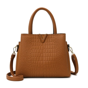 Deep brown crocodile embossed tote bag with gold V-buckle and adjustable shoulder strap