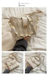 Detail of off-white quilted handbag with silk scarf chain strap and wood grain buckle
