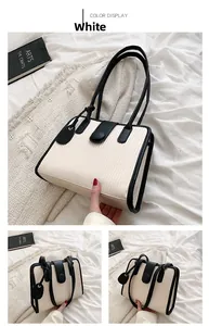 Detail view of large capacity white tote bag with black trim and vertical textured pattern