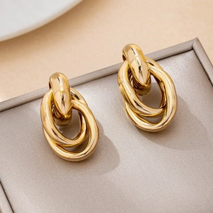 Minimalist double linked gold oval hoop earrings displayed on premium jewelry box