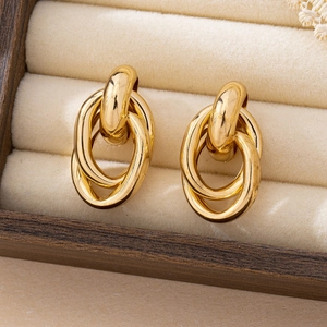 Close-up of interlocking triple oval gold hoop earrings in a velvet jewelry box