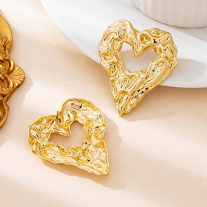 Lava texture hollow heart earrings in polished gold with organic metallic finish