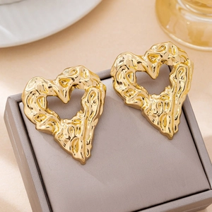 Lava texture hollow heart stud earrings in gold with a modern minimalist metallic finish