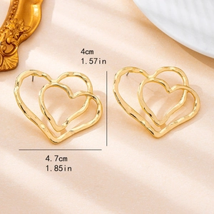 Fashionable hollow double heart stud earrings in polished gold metal for women