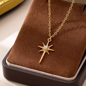 Elegant gold-plated starburst pendant necklace with zircon on a velvet jewelry box
