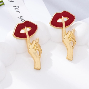 Macro detail of pop art red lips and silence gesture earrings on a wavy white stand