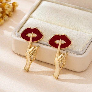 Retro red lips and golden gesture stud earrings in a cream velvet jewelry box